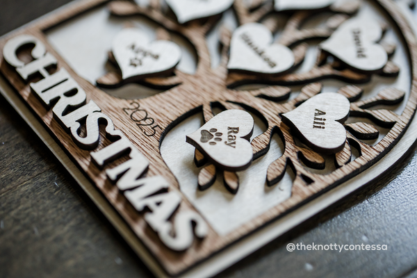 Close up shot of the engraved name for a dog and paw on the ornament
