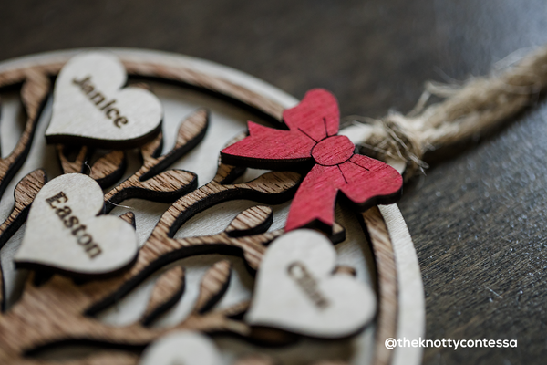 Close up shot of a red bow on the Family Tree ornament